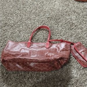 A red and cream colored E Goyard Tote and matching wallet.